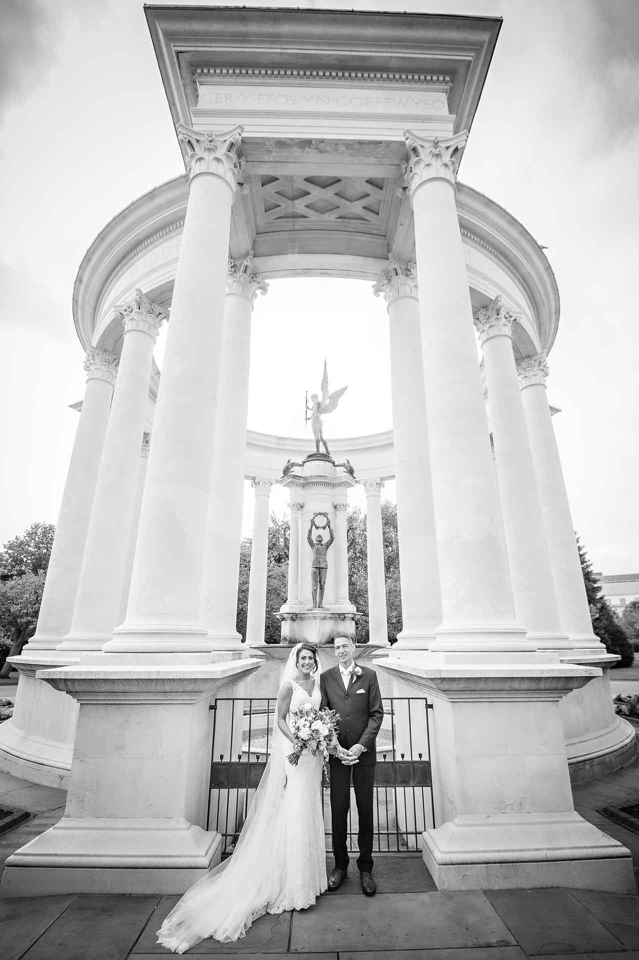 Portrait of bride and groom taken in front of the Welsh National War Memorial in Alexandra Gardens, Cardiff